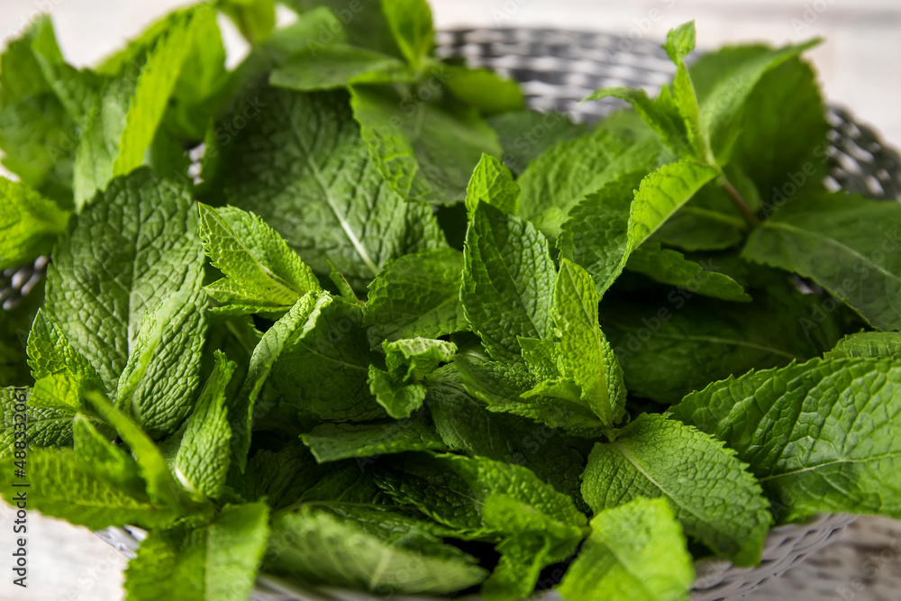 Fresh mint leaves on wicker bowl