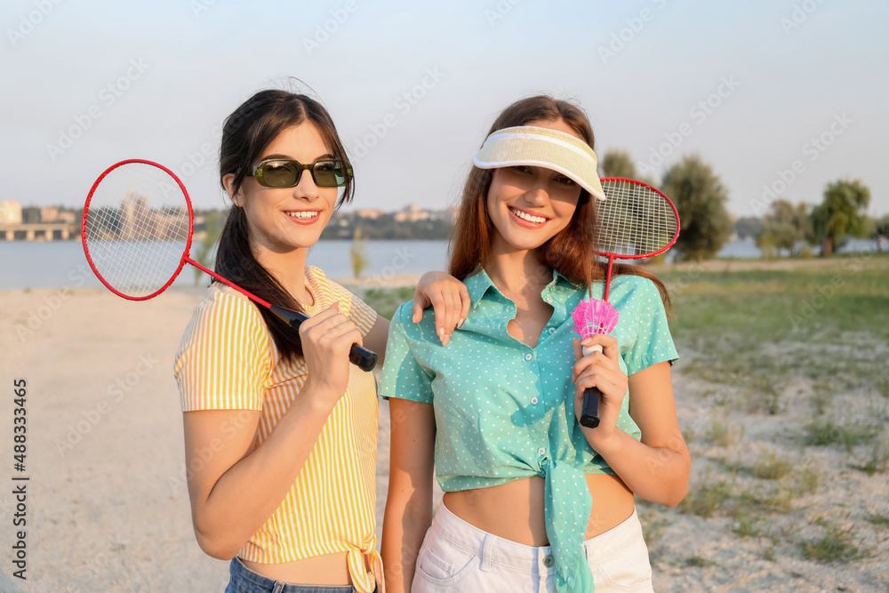 Female badminton players outdoors on summer day