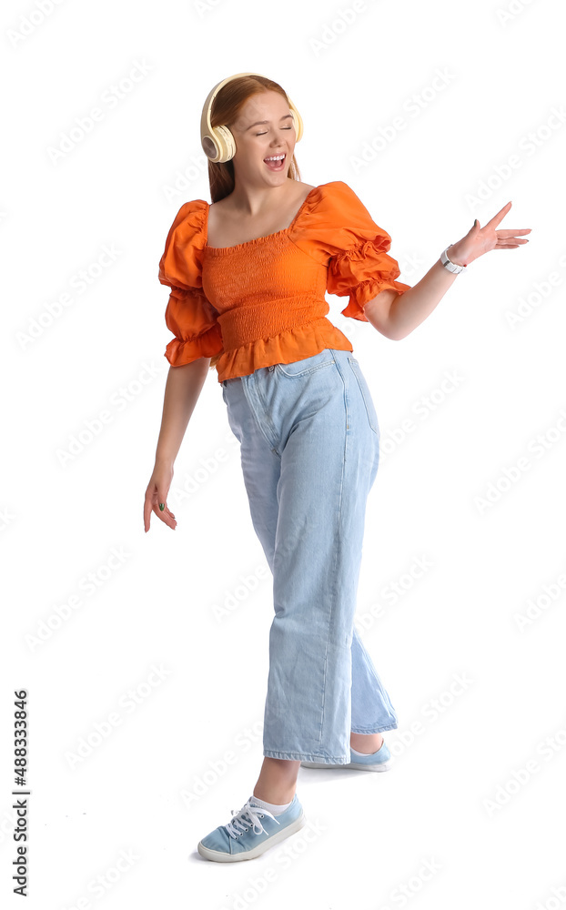 Cool young woman listening to music on white background