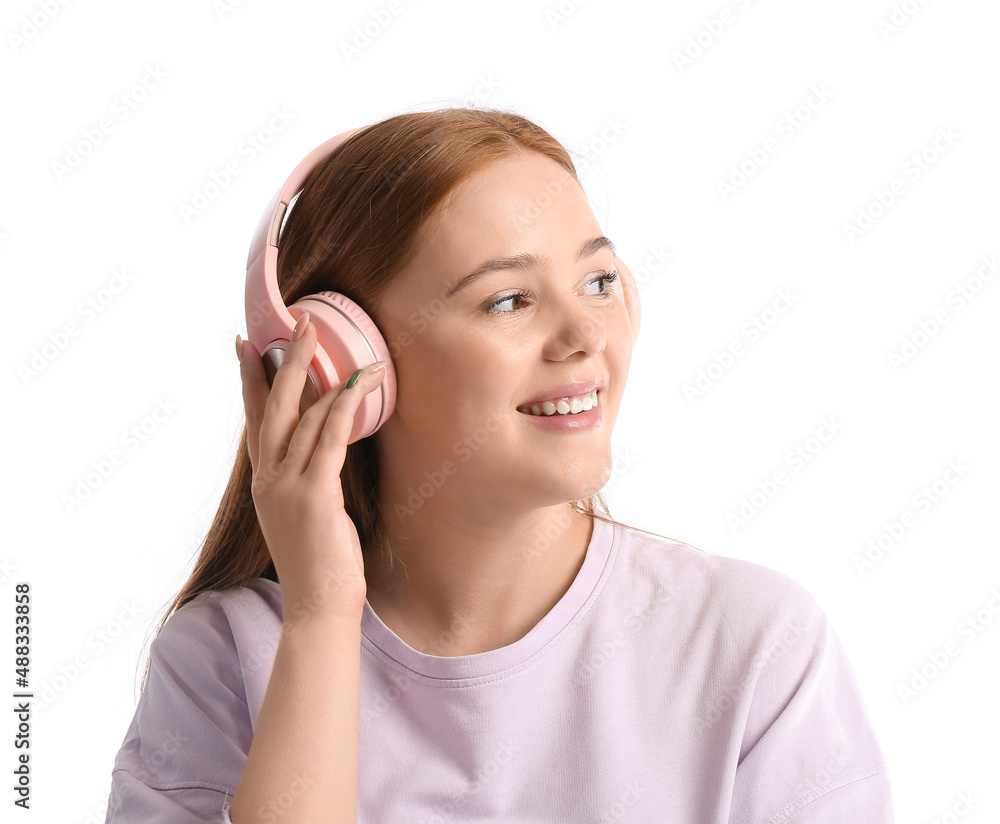 Cool young woman listening to music on white background