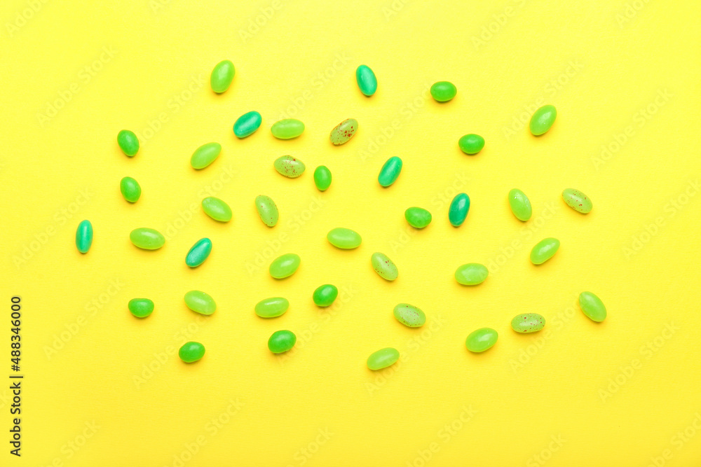 Different jelly beans on yellow background