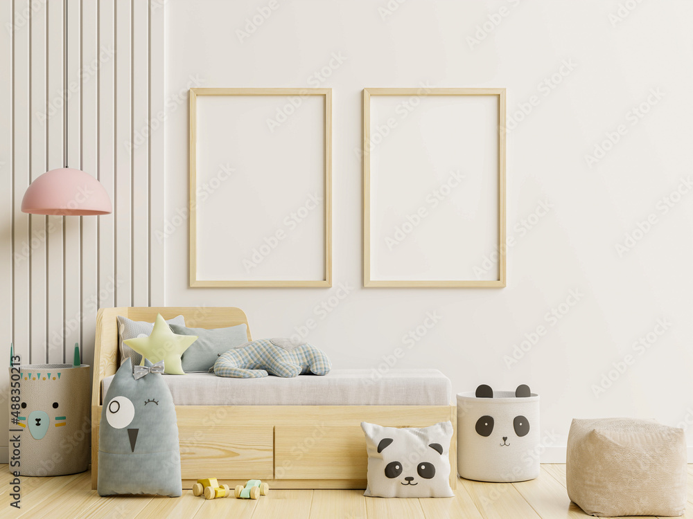 Frame poster mockup in children room interior on empty white wall background.