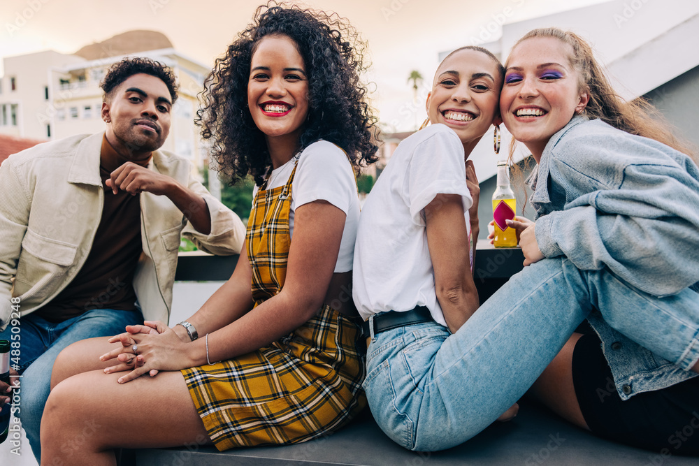 Cheerful friends having a good time on a rooftop