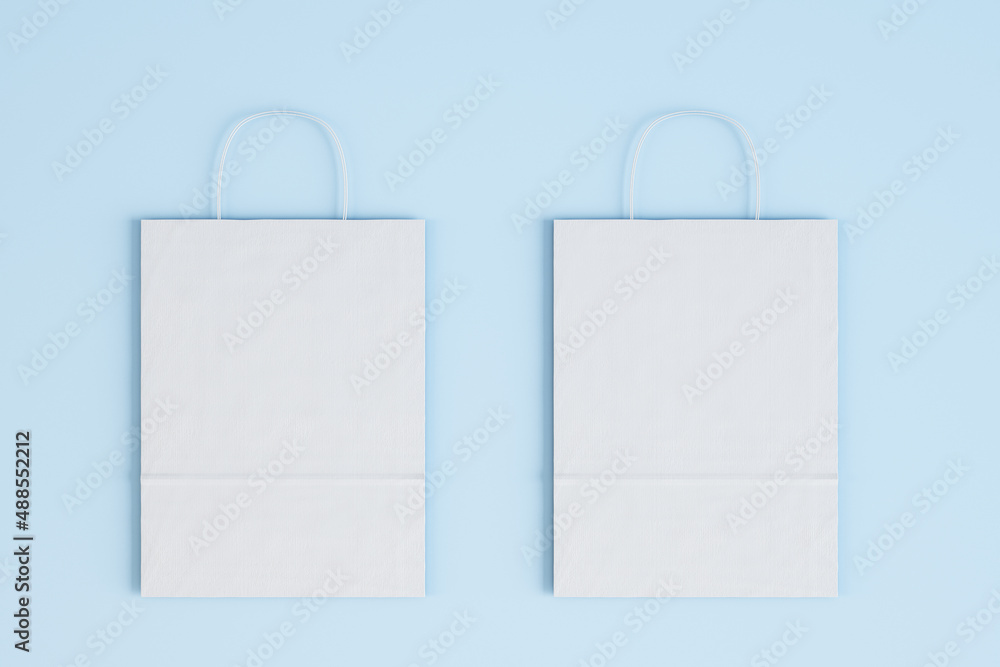 Close up of empty white paper bag on blue wallpaper. Shopping concept. Mock up, 3D Rendering.