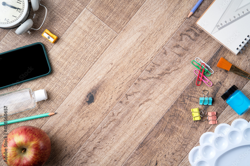 Back to school design concept with stationery over wooden table background.