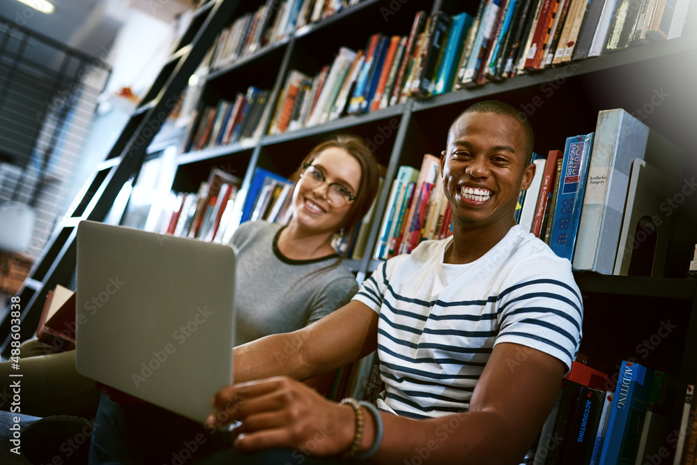 Best studdy buddy ever. Portrait of a young man and woman using a laptop together in a college libra