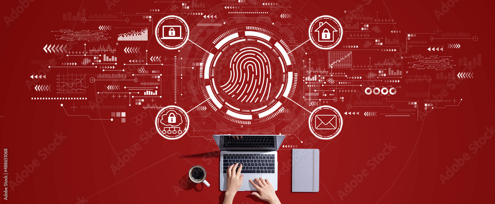 Fingerprint scanning theme with person working with a laptop