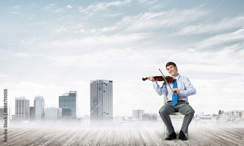 young businessman playing violin