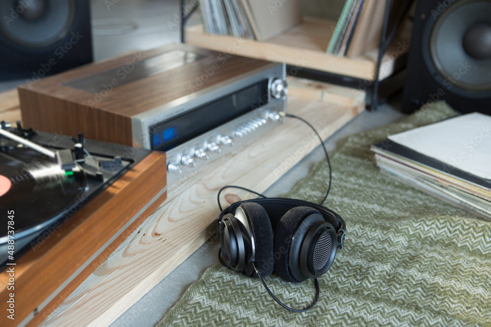 HiFi system with turntable, amplifier, headphones and lp vinyl records in a listening room