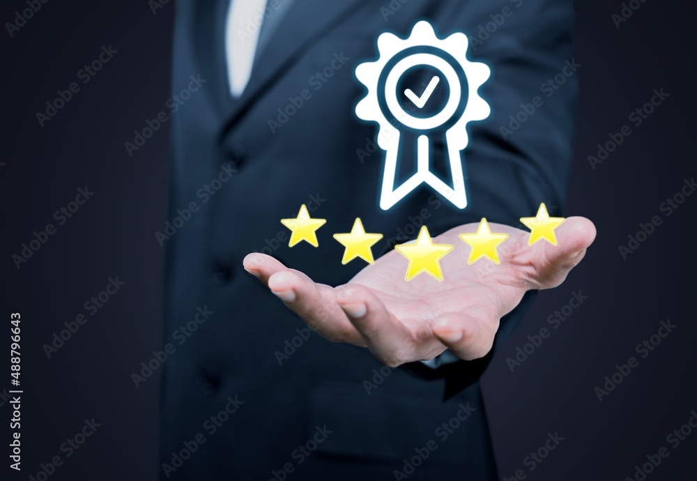 Businessman holding and showing the best quality assurance with golden stars for guarantee product