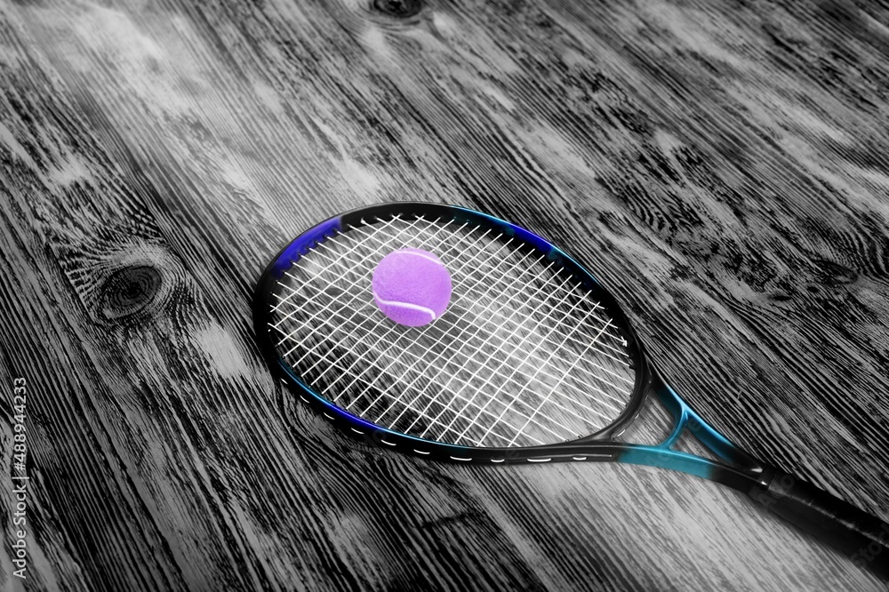 A professional paddle tennis racket with natural lighting on background.