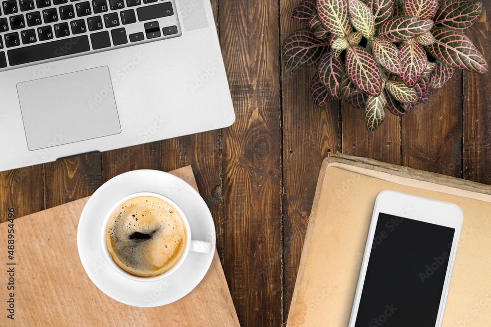 Home office workspace with office supplies: laptop, cup of coffee. Fall, autumn concept.