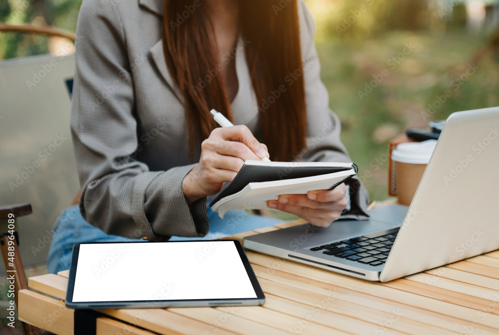 businessman hand working with new modern computer and writing on the notepad