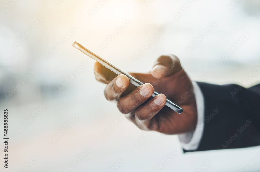 Making moves in the corporate world. Closeup shot of an unrecognisable businessman using a cellphone