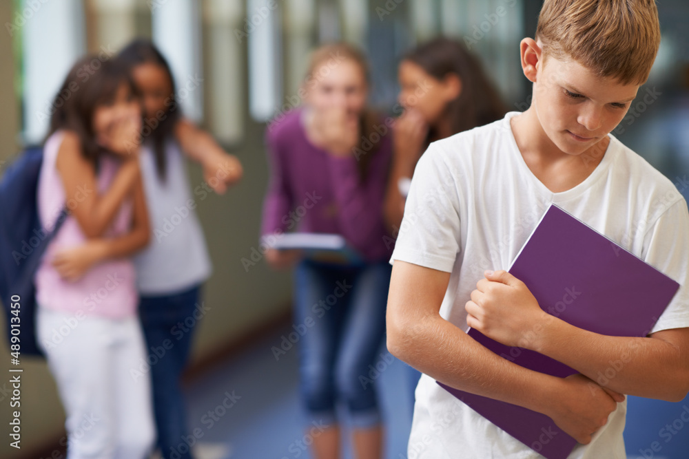 Being made to feel like an outcast. A young boy being bullied at school.