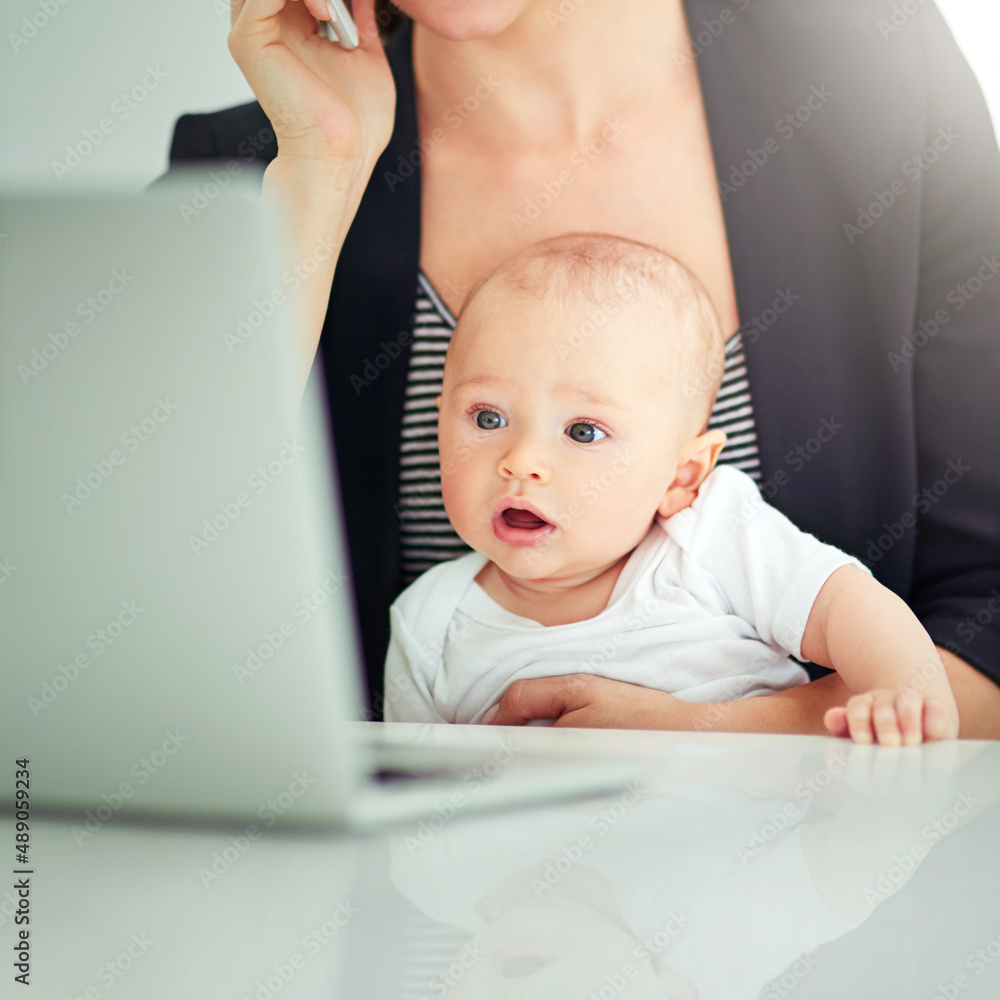 Whatcha working on there, Mom. Shot of an adorable baby boy curious about his mothers work on her co