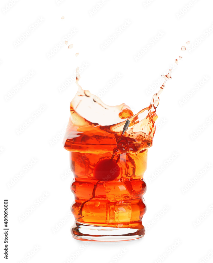 Glass of tasty Manhattan cocktail with splashes isolated on white background