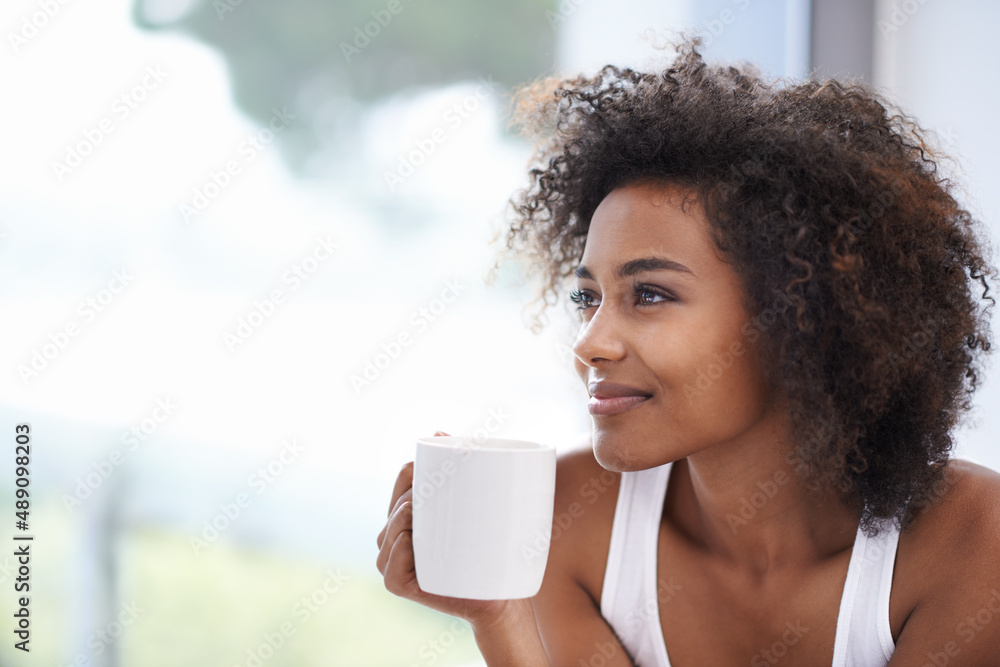 The soothing smell of fresh morning coffee. Cropped shot of a young woman enjoying a cup of coffee.