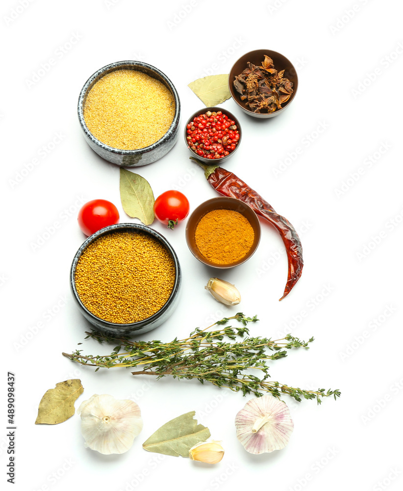 Bowls of different spices and herbs on white background