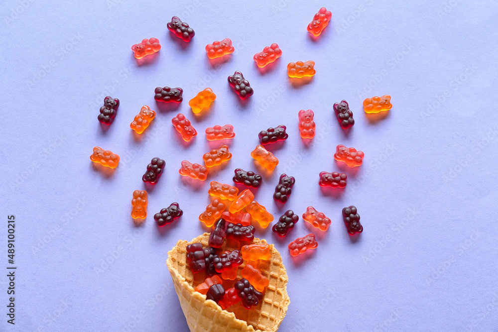 Wafer cone with sweet jelly bears on blue background