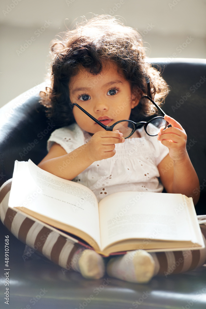 Learning as she grows. Shot of a cute little girl at home.