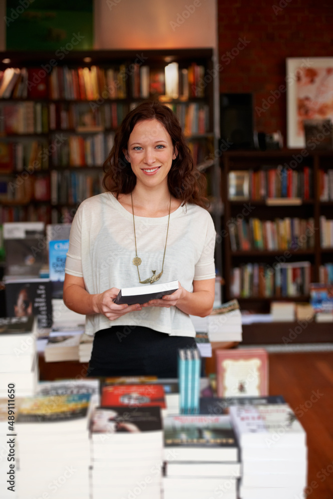 Looking for that perfect read. Portrait of a smiling woman browsing in a bookstore.