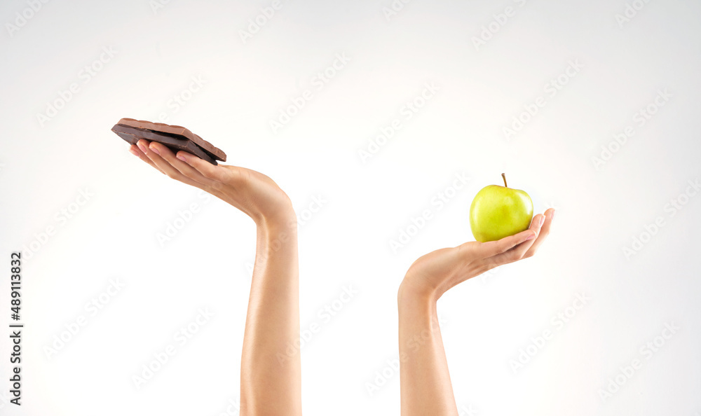 Why cant I choose both. Studio shot of an unrecognizable woman deciding between healthy and unhealth