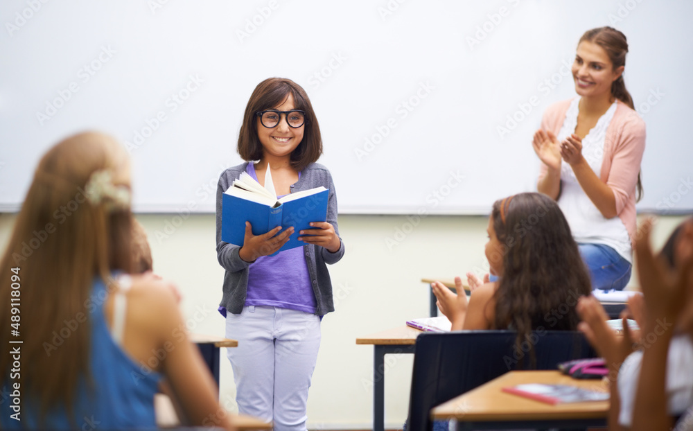 Prepared reading. A young girl doing prepared reading at the front of the class.