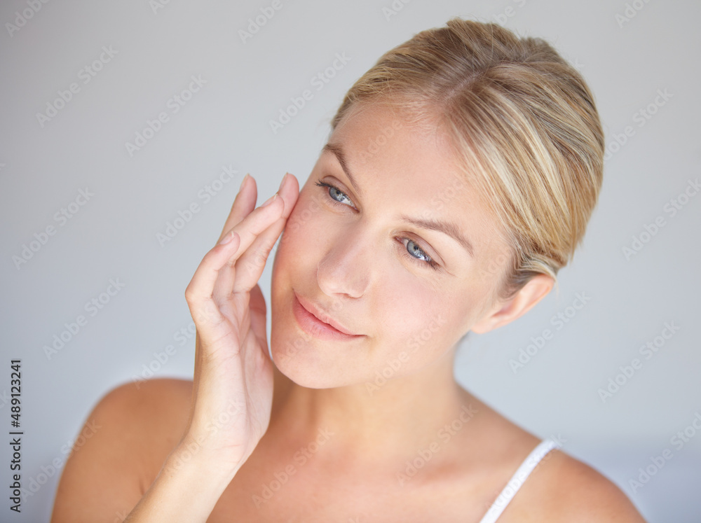 Goodbye wrinkles, hello flawless skin. Cropped shot of a beautiful woman touching her face.