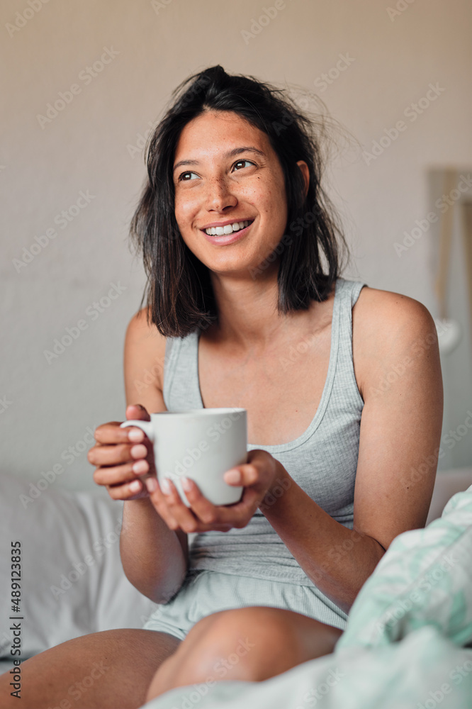 I cant wait to see what this day will bring. Shot of a young woman enjoying a relaxing cup of coffee