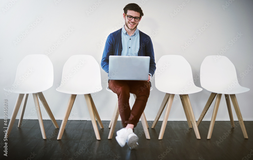 Im well prepared, thanks to the internet. Shot of a young businessman using a laptop while waiting i