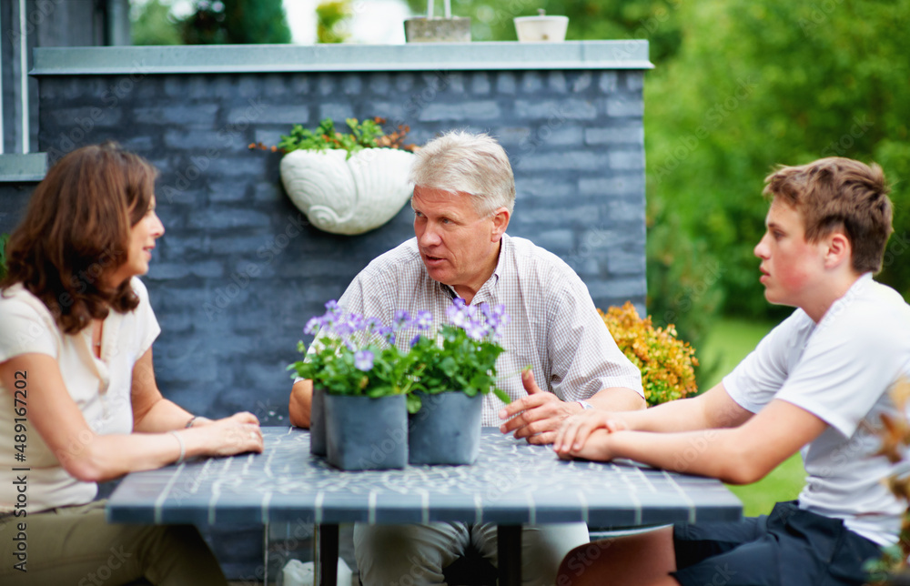 Family bonding. Cropped shot of a senior couple sitting outside with their grandson.