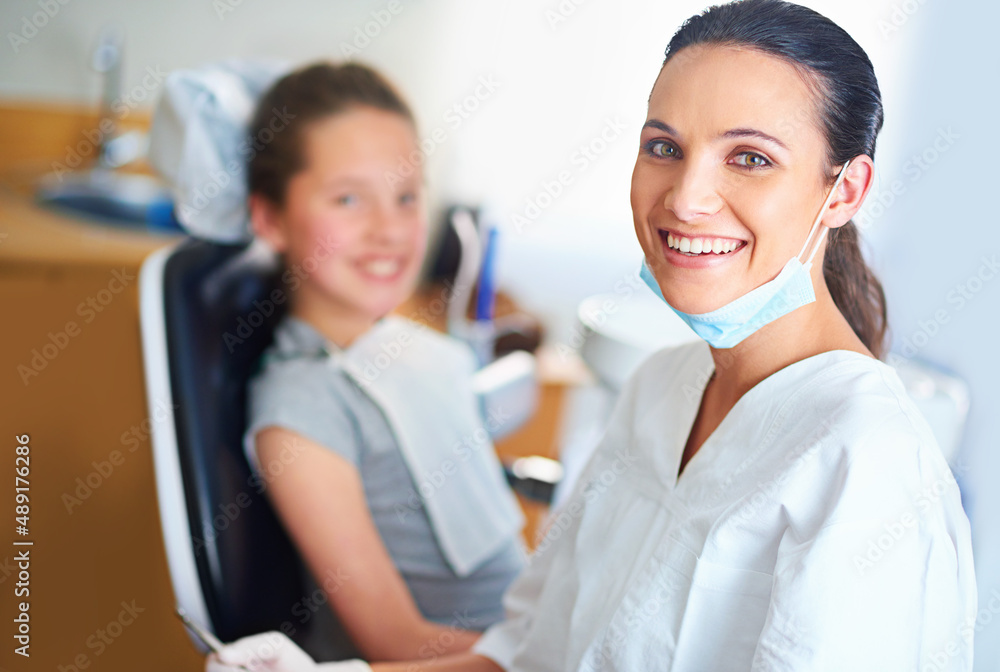 I always try to put my patients at ease. Portrait of a female dentist and child in a dentist office.