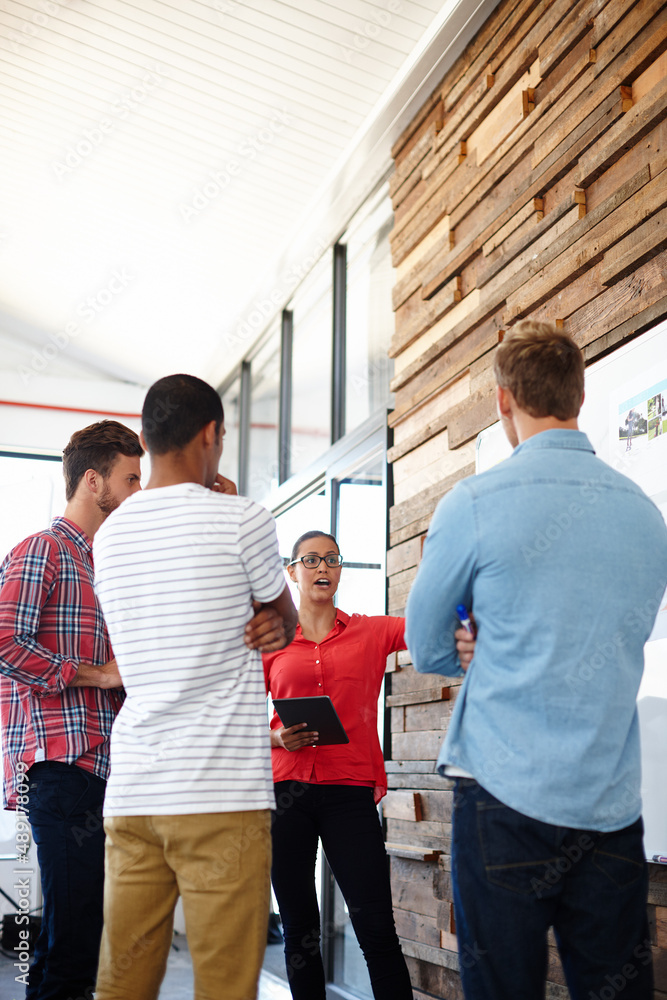 Creative developments. Shot of a group of designers discussing ideas in a meeting.