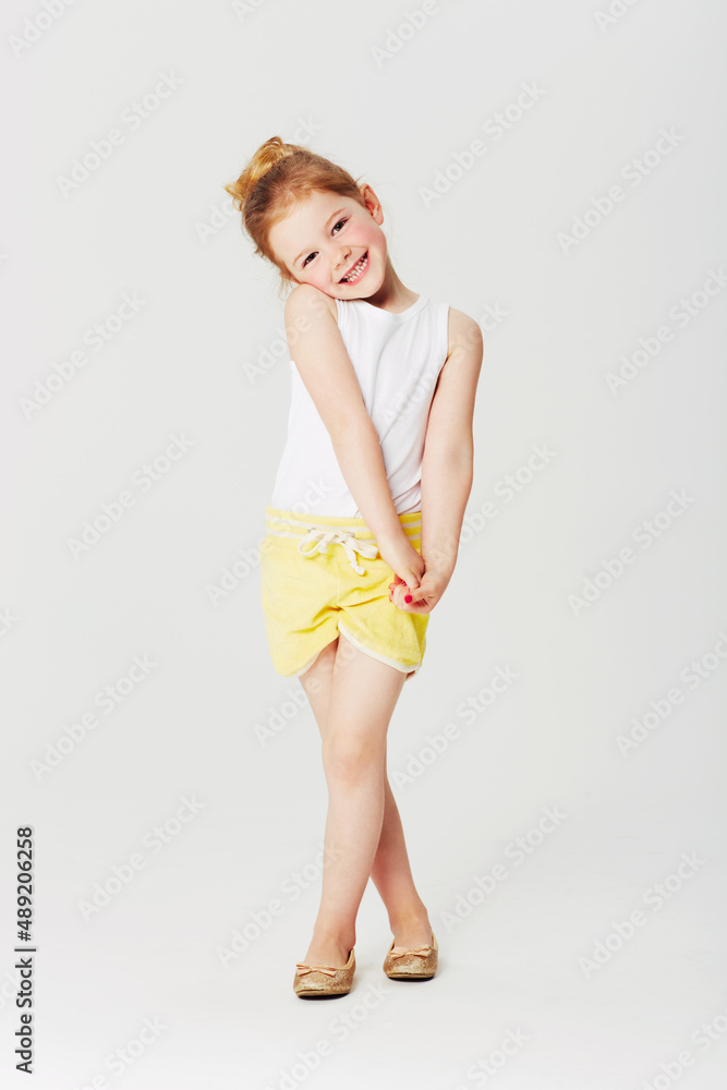 Please, pretty please...... Full length studio portrait of an adorable little girl in a sweet pose.