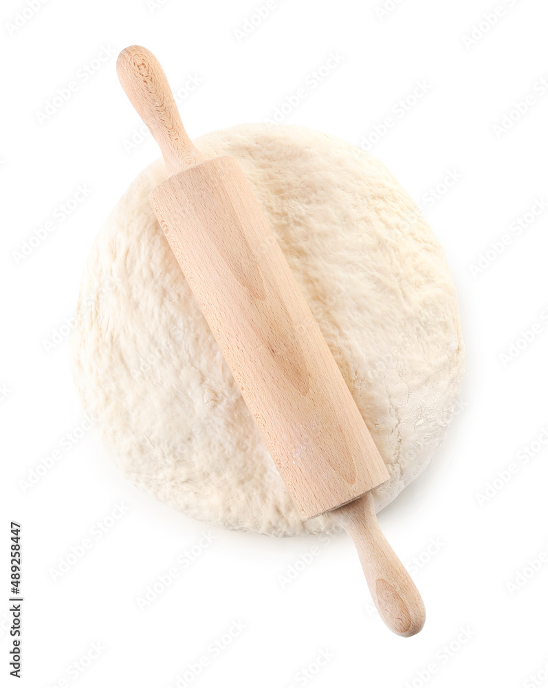 Raw dough with rolling pin on white background