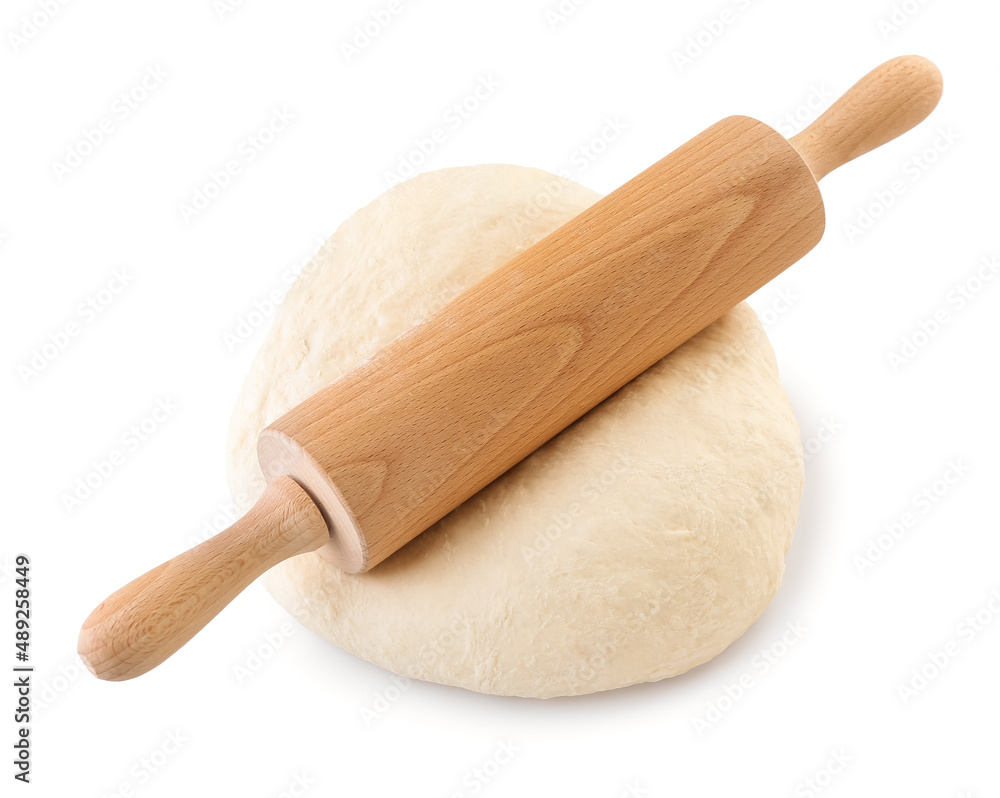 Raw dough with rolling pin on white background