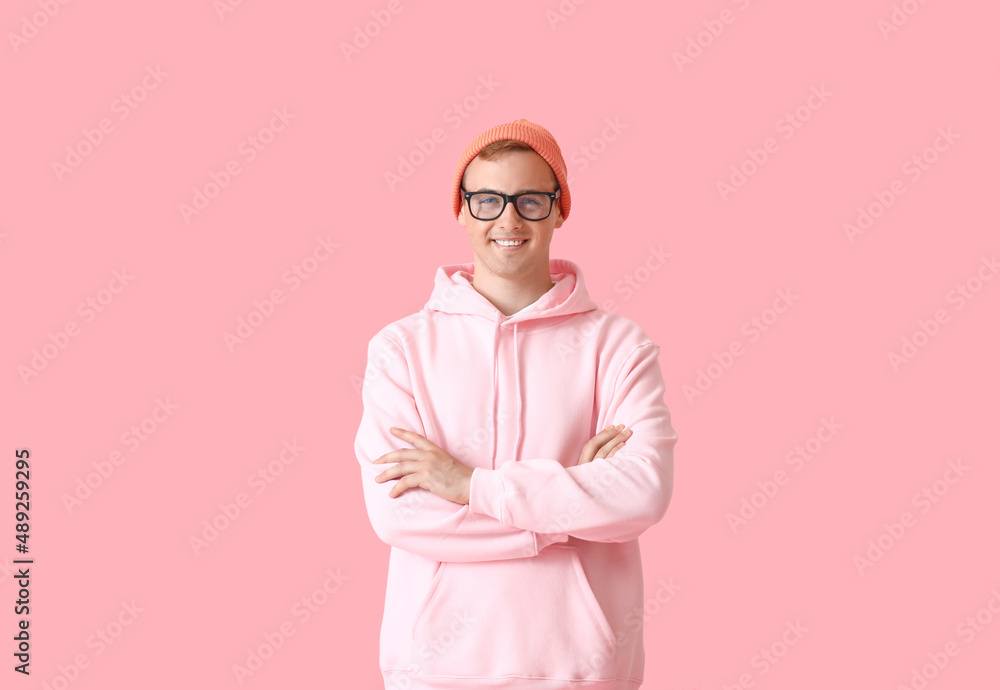 Young guy in stylish hoodie on color background