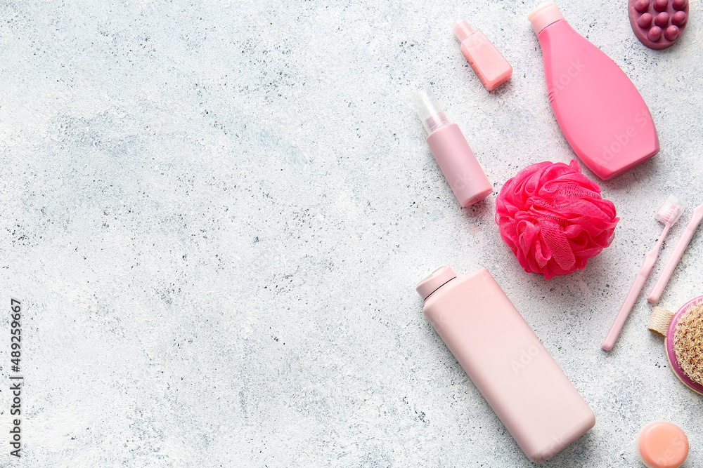 Set of cosmetics and bath accessories on light background