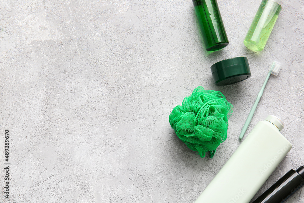 Cosmetic products, toothbrush and sponge on light background