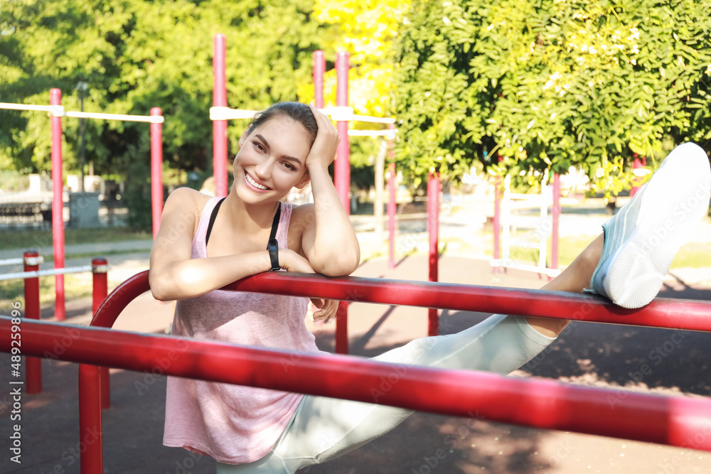 Sporty young woman exercising on sport ground