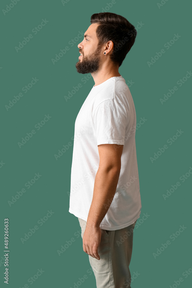 Handsome man in white t-shirt on green background