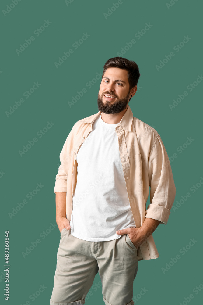 Handsome man in white t-shirt on green background