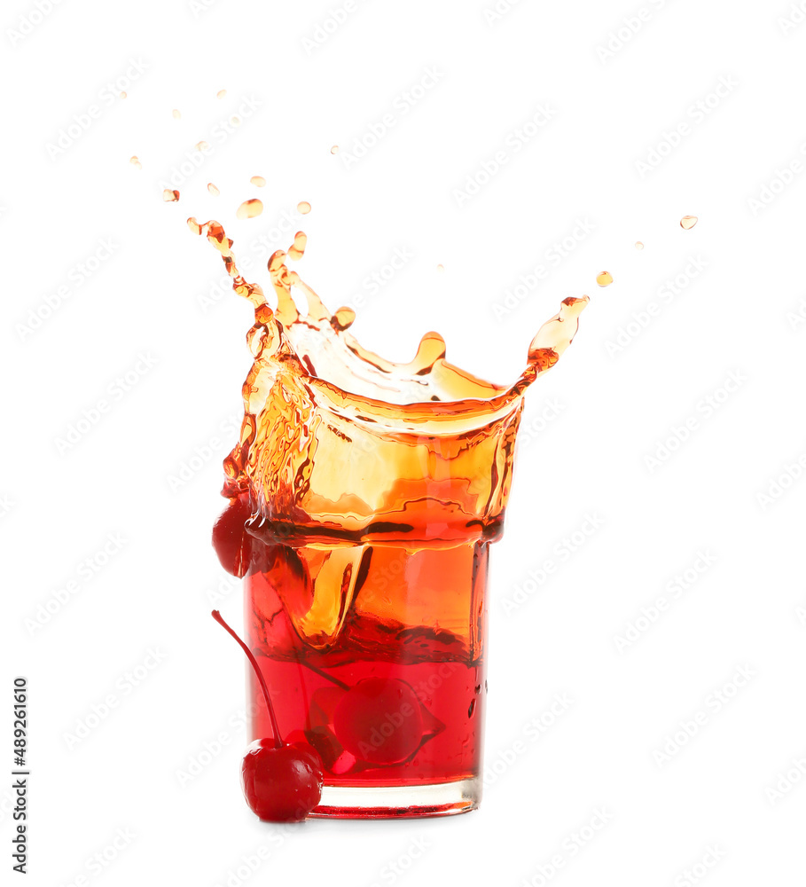 Glass of tasty Manhattan cocktail with splashes isolated on white background