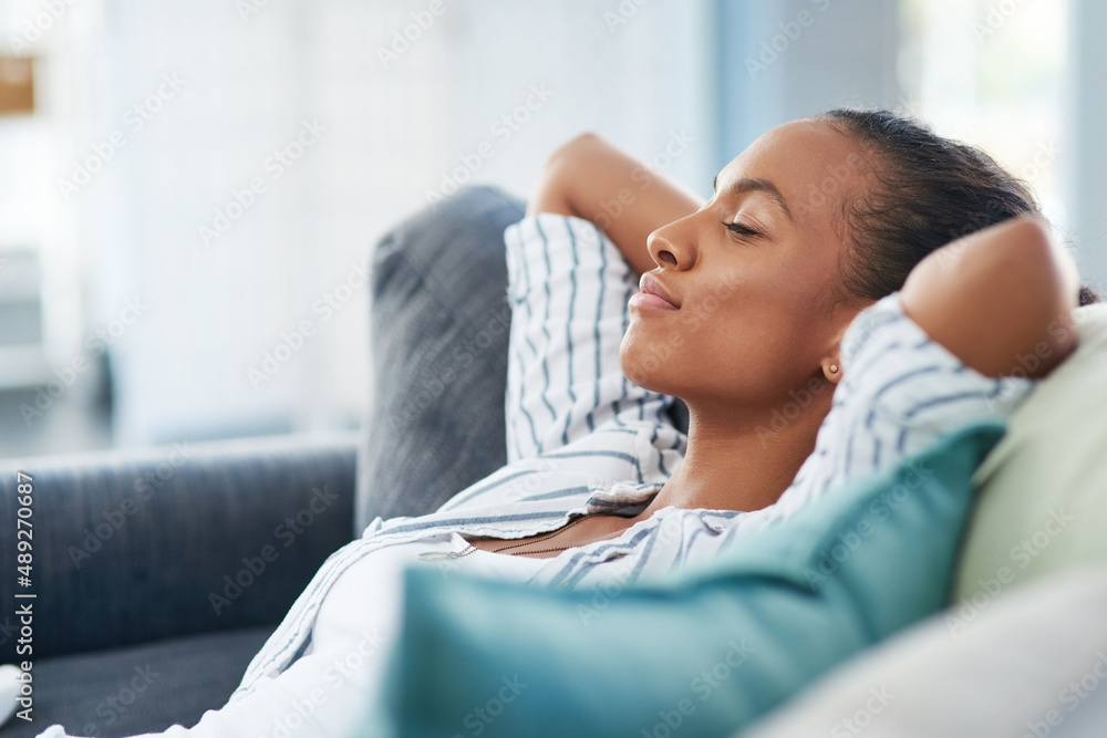 What a quiet and peaceful Sunday afternoon. Shot of a young woman sleeping on the sofa at home.