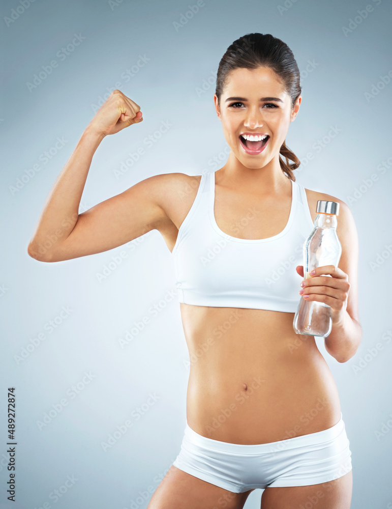 Itll be worth it once you reach your goal. Studio portrait of an attractive young woman cheering whi