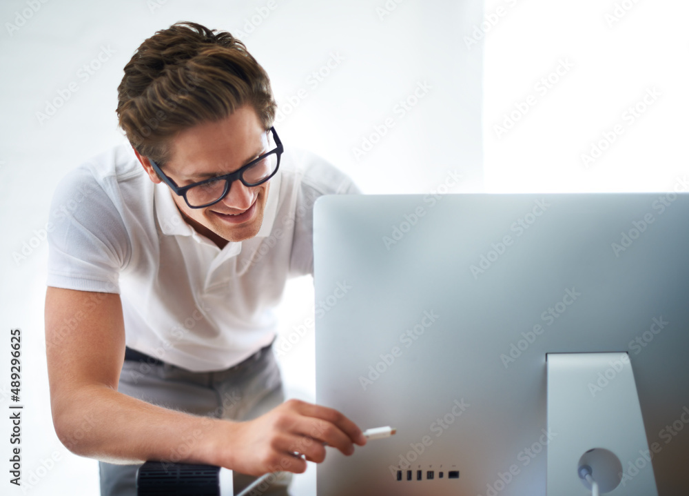 Ive got this. A computer technician plugging a computer in.