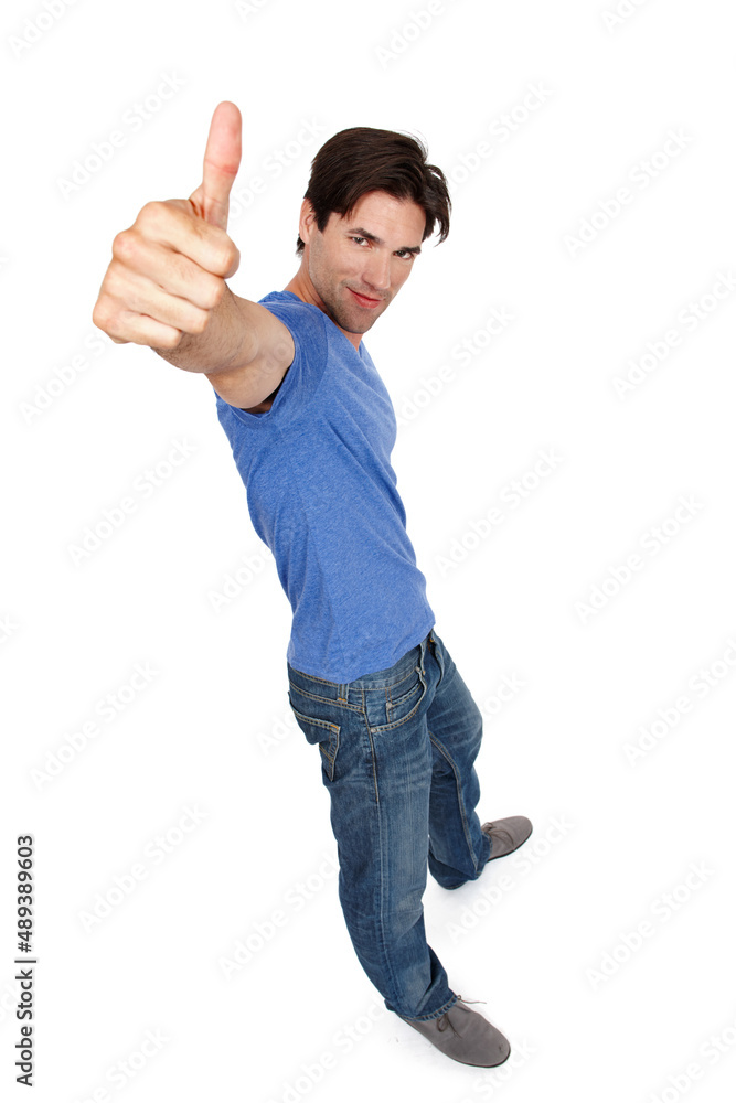 Giving you the go-ahead. High angle studio portrait of a handsome young man showing thumbs up.