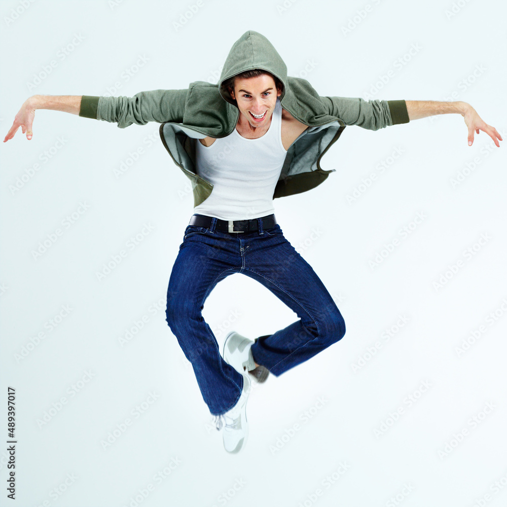 Airborne posing. Portrait of a young man jumping up and posing while in the air.