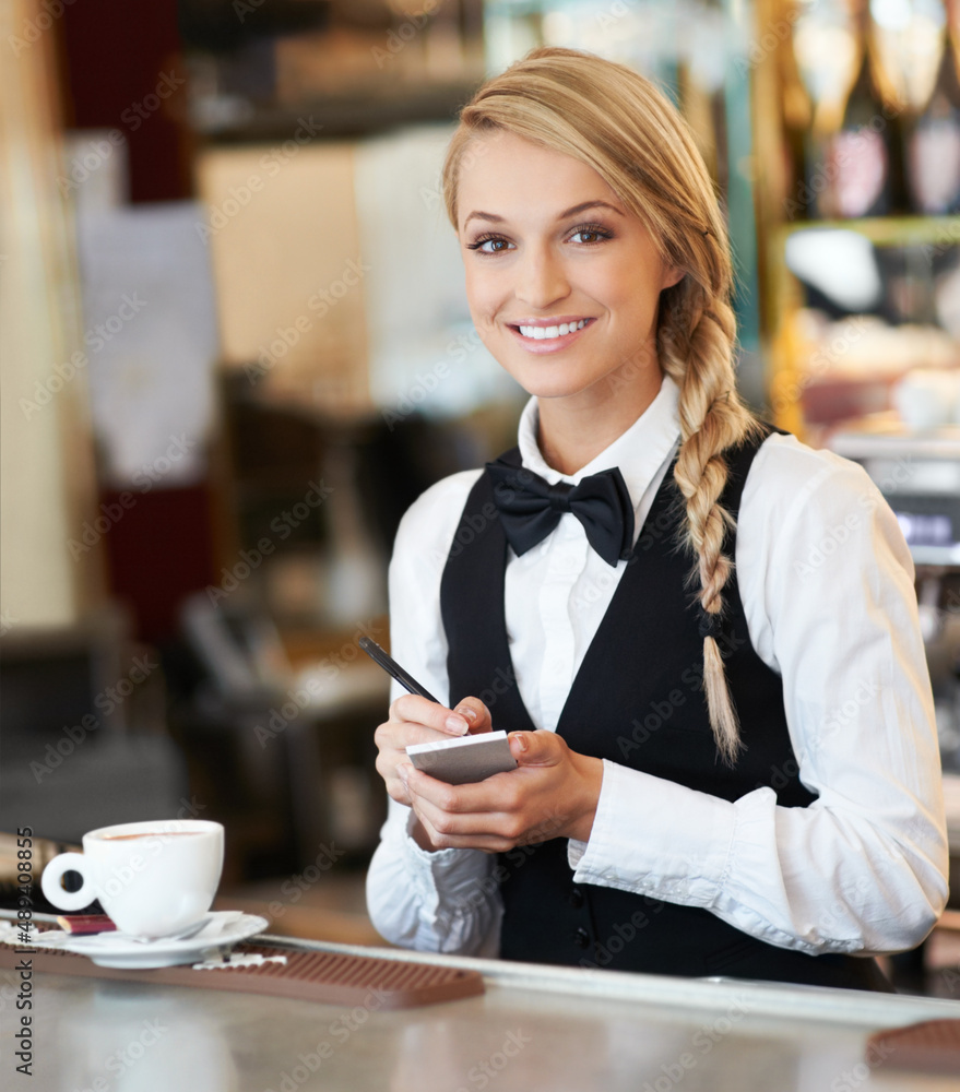 Service with a smile. Portrait of an attractive waitress taking coffee orders for the morning.